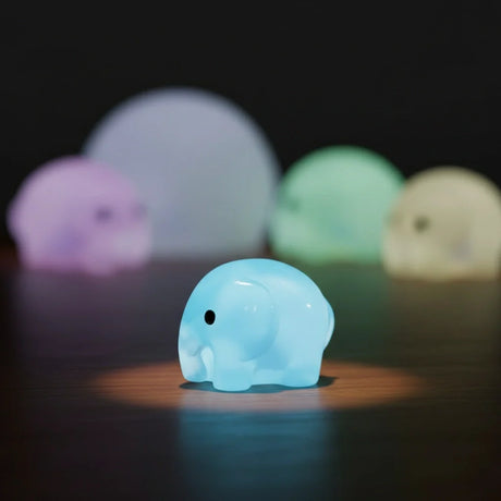 Miniature Glow Elephant Assorted (1pc) glowing in a dark setting