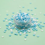 Miniature Polymer Clay SnowFlakes (10pcs) on the light blue background.
