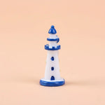 Miniature Sea Side Watch Light Tower (1pc) on the light peached background.