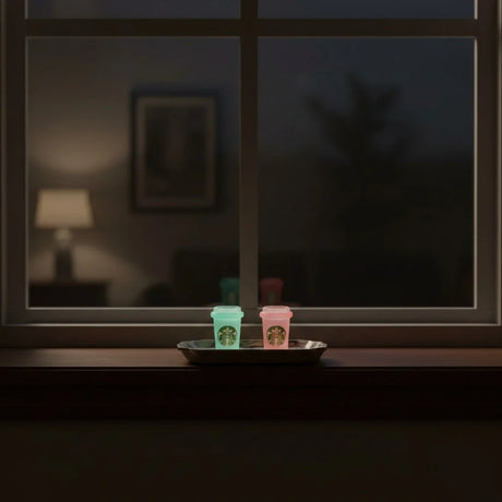 Miniature Glow Starbucks Cup Assorted (1pc) glowing on a windowsill in a dimly lit room