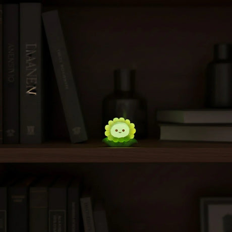 Miniature Glow Sunflower Assorted (1pc) glowing on a dark bookshelf