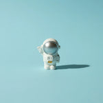 Miniature Astronaut miniature on the Blue Background.