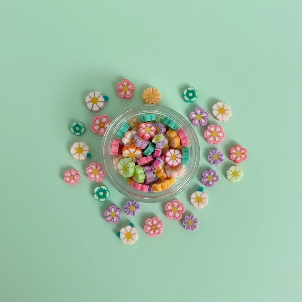 Miniature Resin Flowers (10 pcs) on the aqua coloured background.