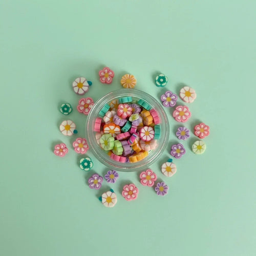 Miniature Resin Flowers (10 pcs) on the aqua coloured background.