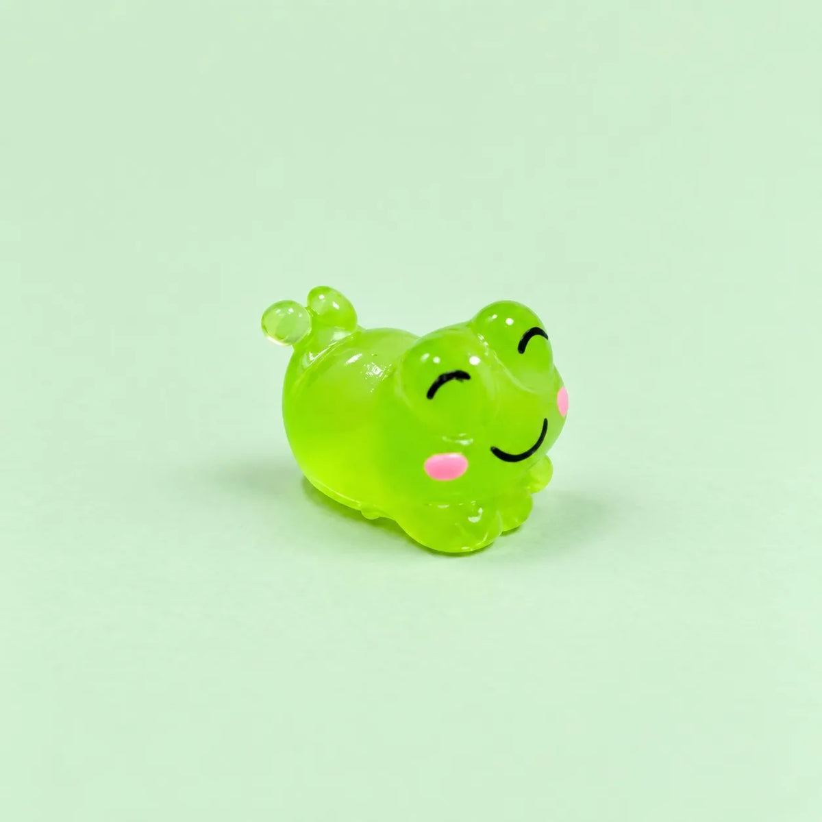 Miniature Glow Cute Resin Frog Assorted (1pc) displayed on a mint green background
