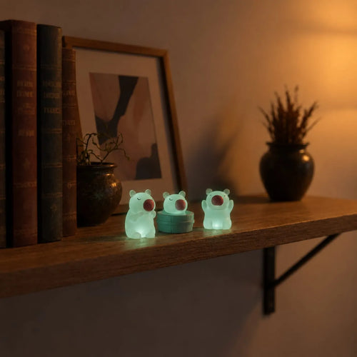 Miniature Glow Cute Pig Assorted (1pc) glowing on a wooden shelf in a dimly lit room