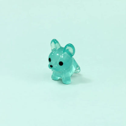 Miniature Glow Mini Dogs Assorted (1pc) displayed on a mint green background