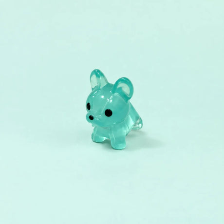 Miniature Glow Mini Dogs Assorted (1pc) displayed on a mint green background