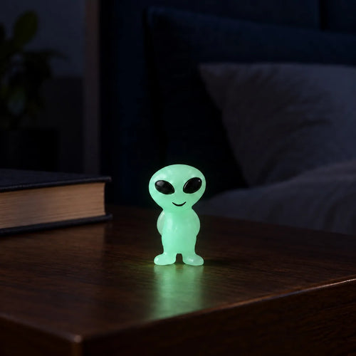 Glow in the Dark Elves (1pc) glowing on a wooden table in a dark setting