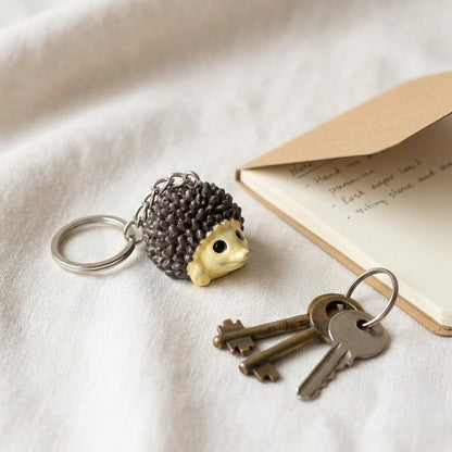 Miniature Porcupine Assorted (1Pc) displayed beside keys and a ring on a soft surface.