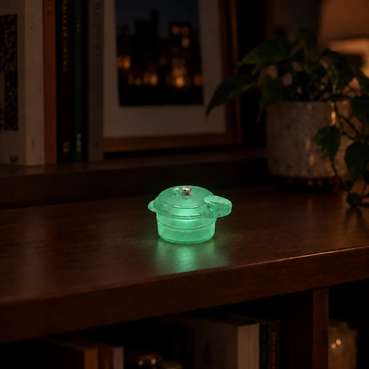 Miniature Glow Mini Cooker Assorted (1pc) glowing on a wooden table in a dimly lit room