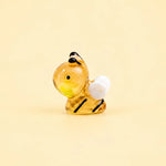 Miniature Glow Bee Assorted (1pc) displayed on a light yellow background