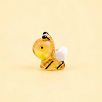 Miniature Glow Bee Assorted (1pc) displayed on a light yellow background