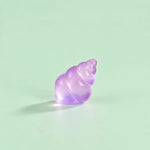 Miniature Glow Conch Shell Assorted (1pc) displayed on a mint green background