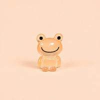 Miniature Glow Frog Assorted (1pc) displayed on a peach background
