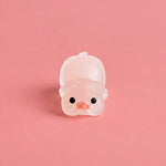 Miniature Glow Pink Yoga Pig Assorted (1pc) displayed on a pink background