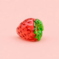 Miniature Glow Strawberries Assorted (1pc) displayed on a pink background