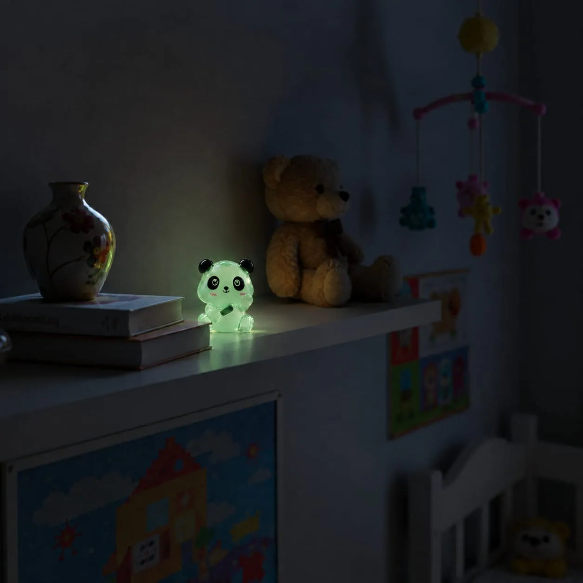 Miniature Glow Panda Assorted (1pc) glowing on a shelf in a dimly lit room