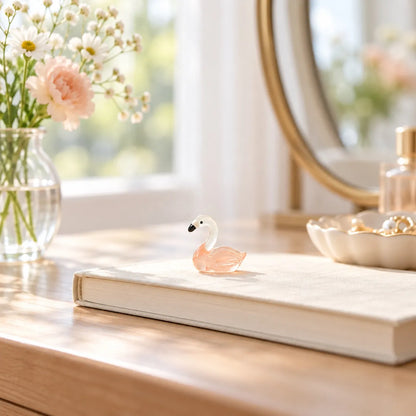 Miniature Glow Swan Assorted (1pc) displayed on a windowsill with decorative items
