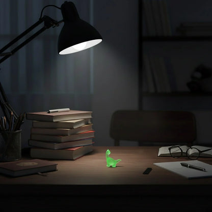 Miniature Glow Resin Dinosaur Assorted (1pc) on the study table