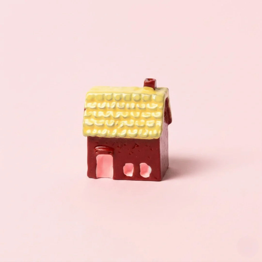 Miniature Resin House Assorted (1Pc) on a light pink background.