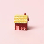Miniature Resin House Assorted (1Pc) on a light pink background.