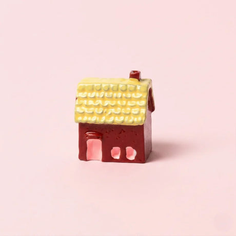 Miniature Resin House Assorted (1Pc) on a light pink background.